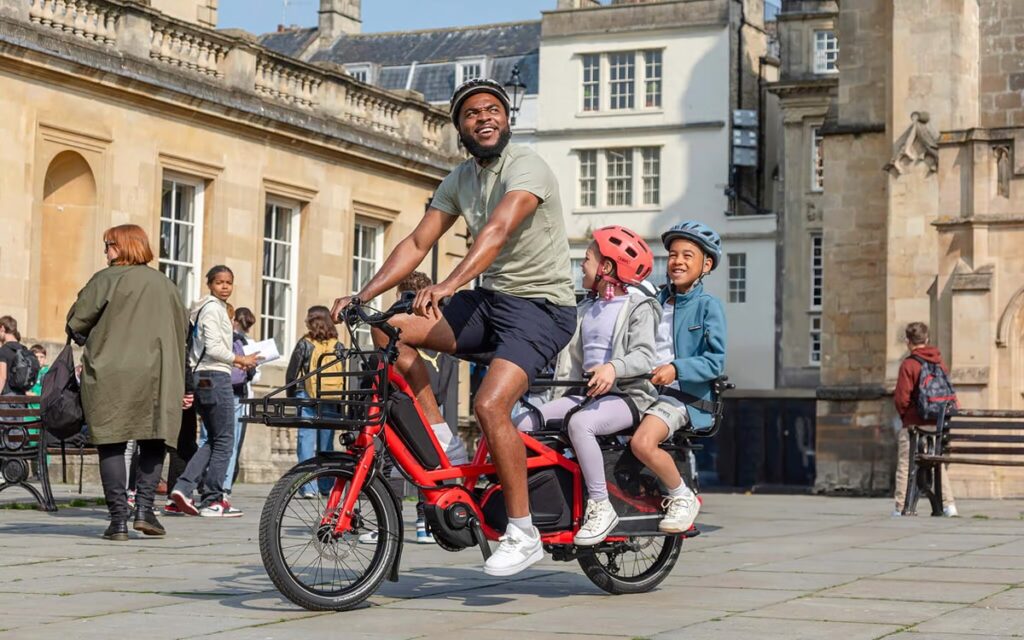 Vélo cargo longtail électrique avec deux enfants sur le porte-bagages arrière