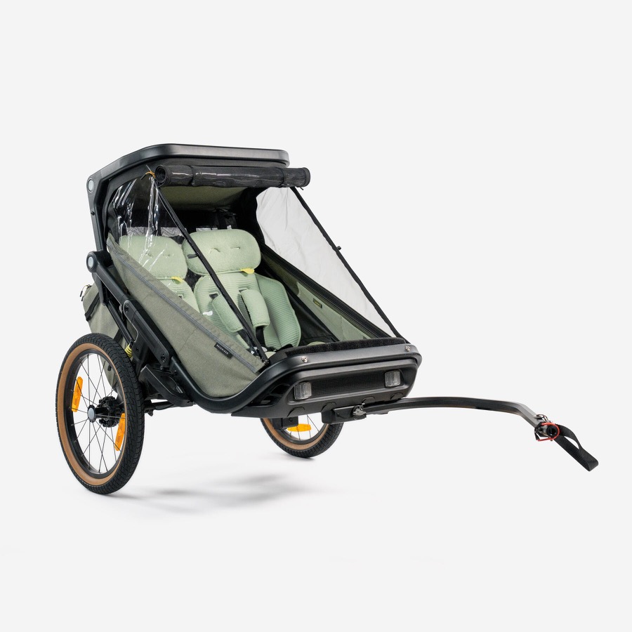 Remorque vélo enfant Rockrider EXPL 900 Decathlon deux places avec coque grise, drapeau de signalisation et timon d'attelage